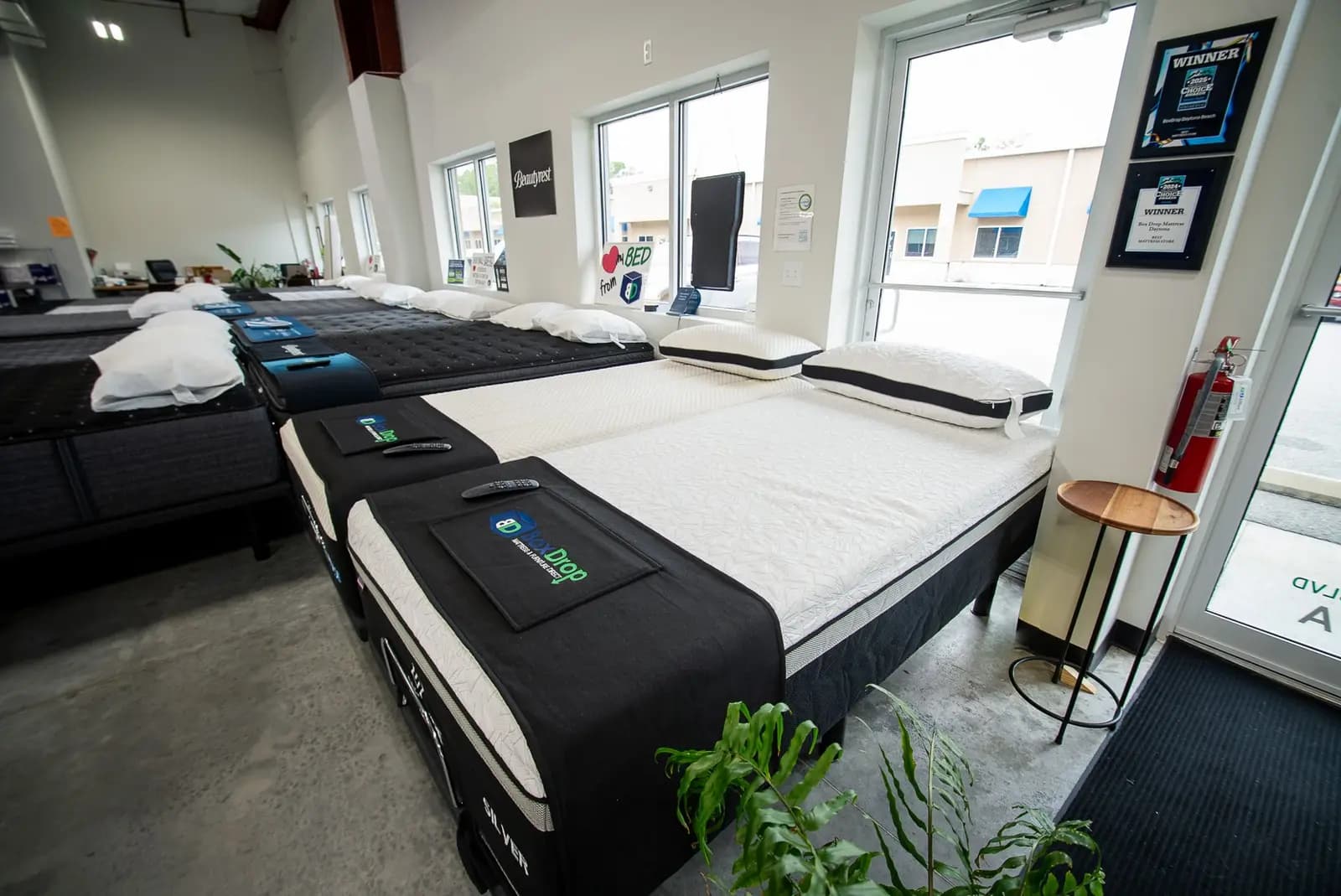 A mattress with a handheld remote on the floor at BoxDrop Daytona Beach